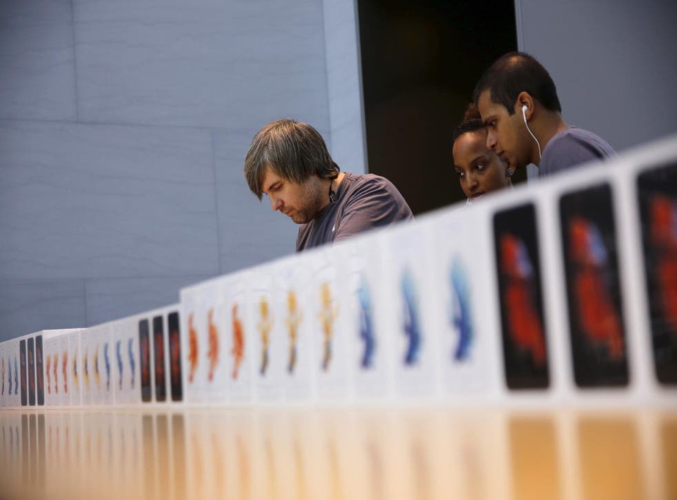 Apple employees take orders for the new iPhone 6S at the Apple Retail in Palo Alto, California September 25, 2015
