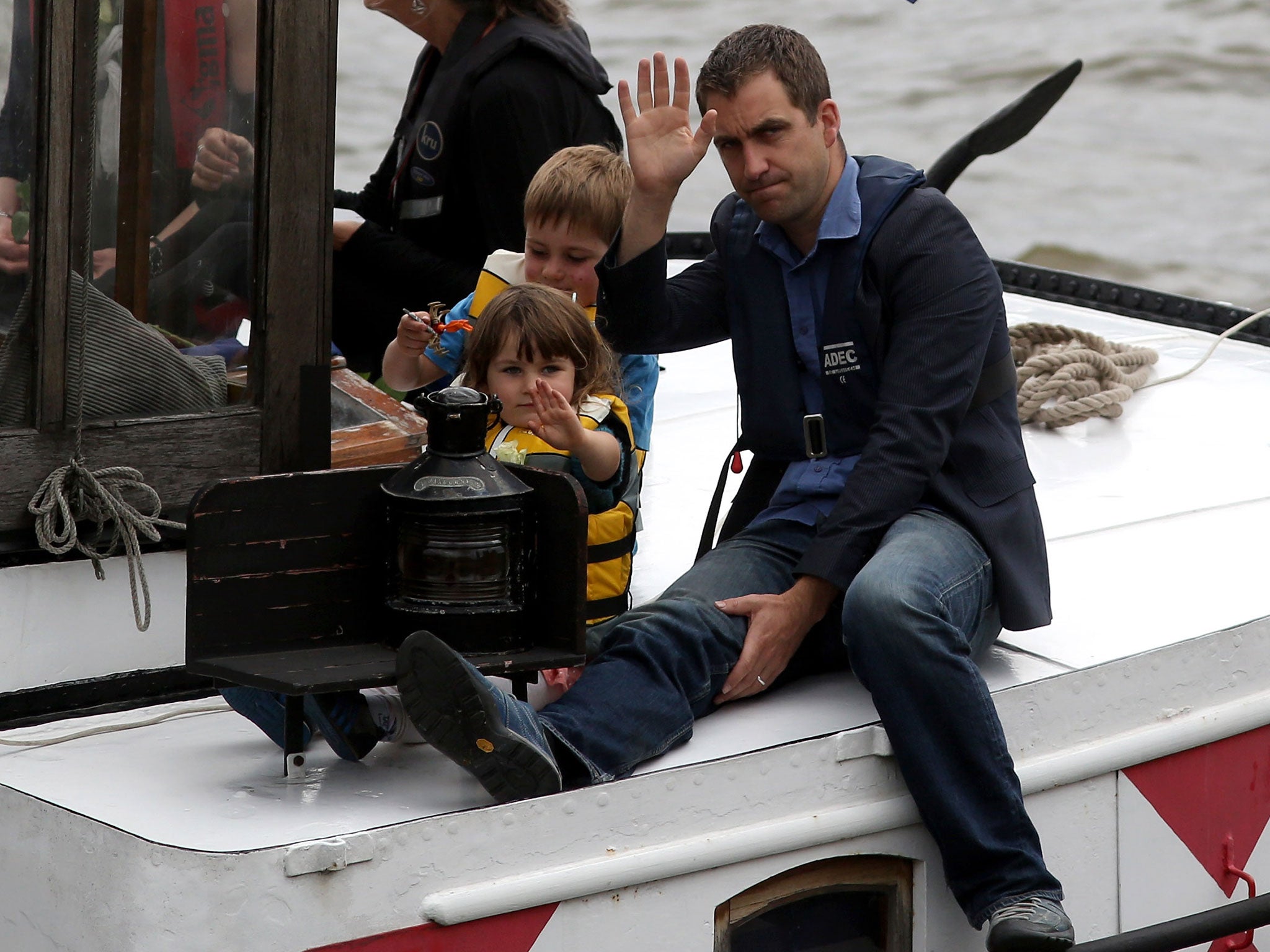 Brendan Cox, husband of Jo Cox, and their children ride on the boat towing a memorial dedicated to the Labour MP down the River Thames