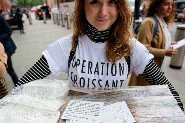 Pro-remain campaigners from 'Operation Croissant', a French pro-EU group, hand out postcards written by Parisians urging people in the UK to vote to remain in the EU