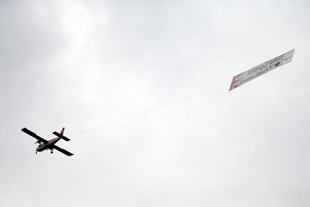 A plane carrying a banner with the words 'Take Control #VoteLeave' emblazoned on it flies above London's Trafalgar Square during a rally in tribute to Jo Cox MP