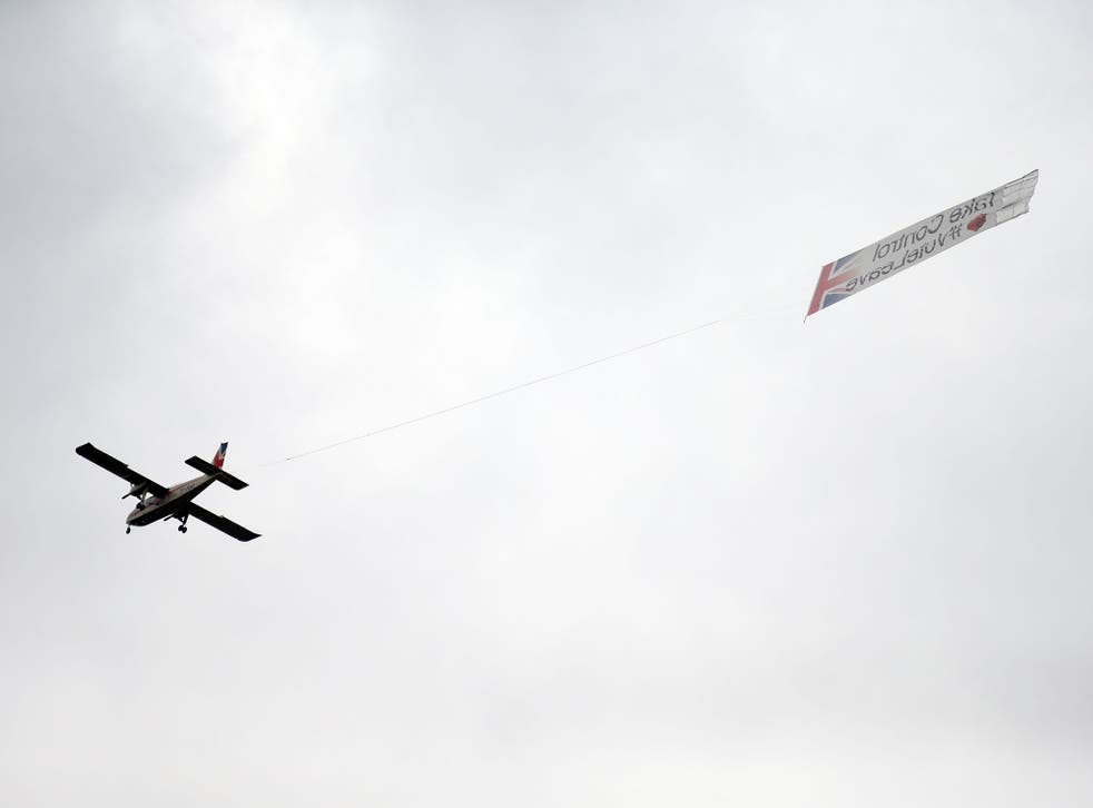 A plane carrying a banner with the words 'Take Control #VoteLeave' emblazoned on it flies above London's Trafalgar Square during a rally in tribute to Jo Cox MP