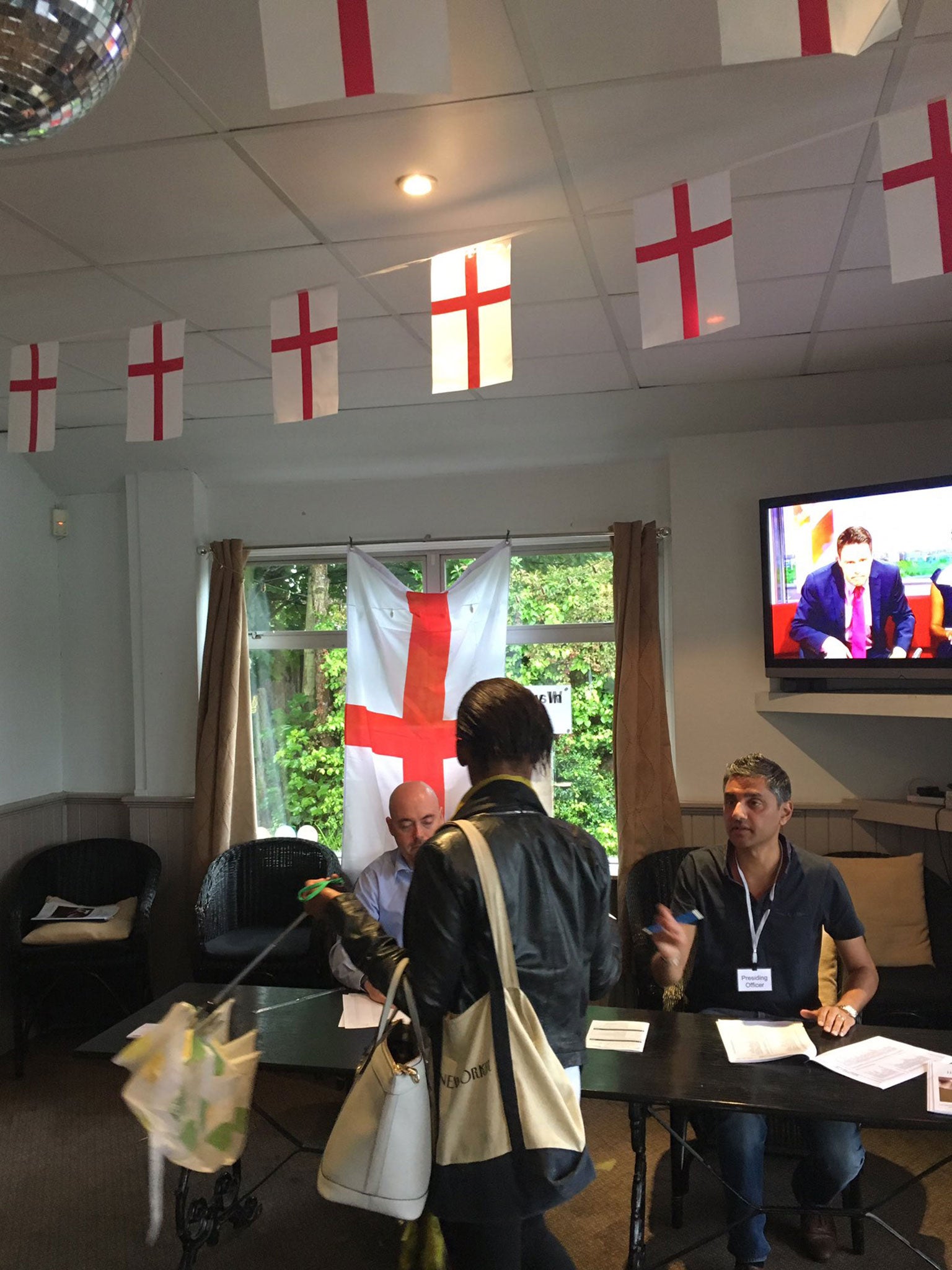 A polling station in Palmers Green, London, was criticised for failing to take down England flags