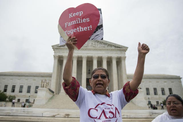 An immigration activist demonstrates outside the US Supreme Court in Washington DC