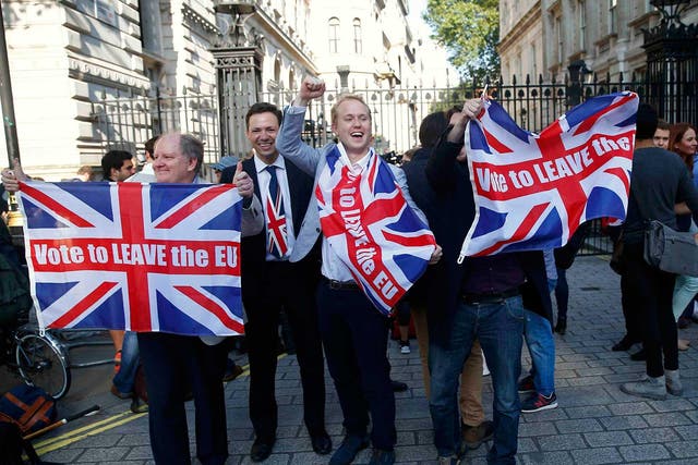 Vote leave supporters wave Union flags, following the result of the EU referendum, outside Downing Street in London