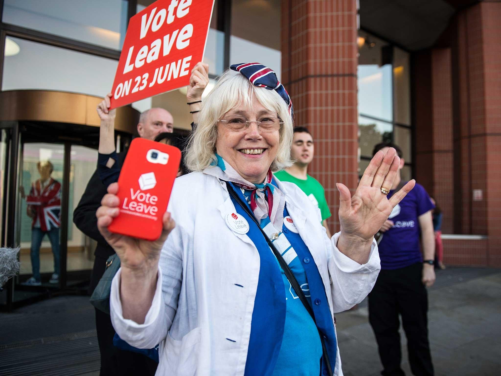 A vote LEAVE supporter Christine Forrester celebrates with others outside Vote Leave HQ, Westminster Tower in London