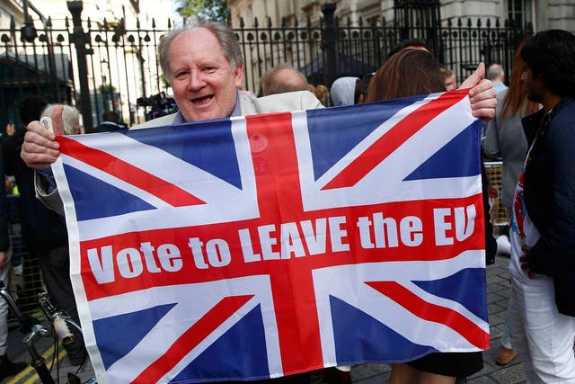 A vote leave supporter holds a Union flag, following the result of the EU referendum, outside Downing Street in London