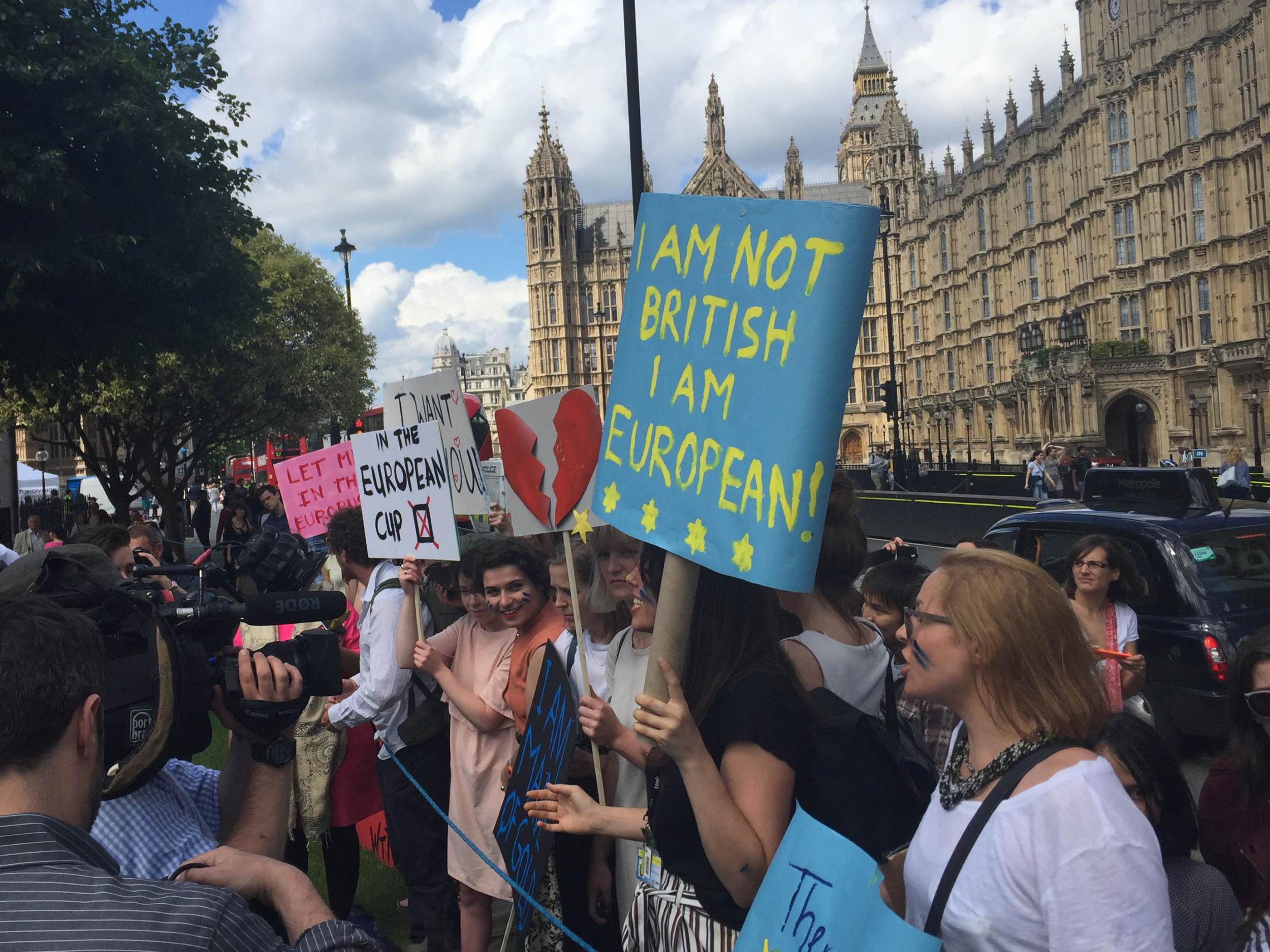 Young people gather outside the Houses of Parliament after the result of the EU referendum is announced