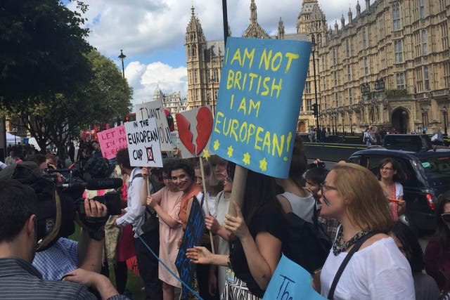 Teenagers gather outside Parliament on the day the Brexit result is revealed