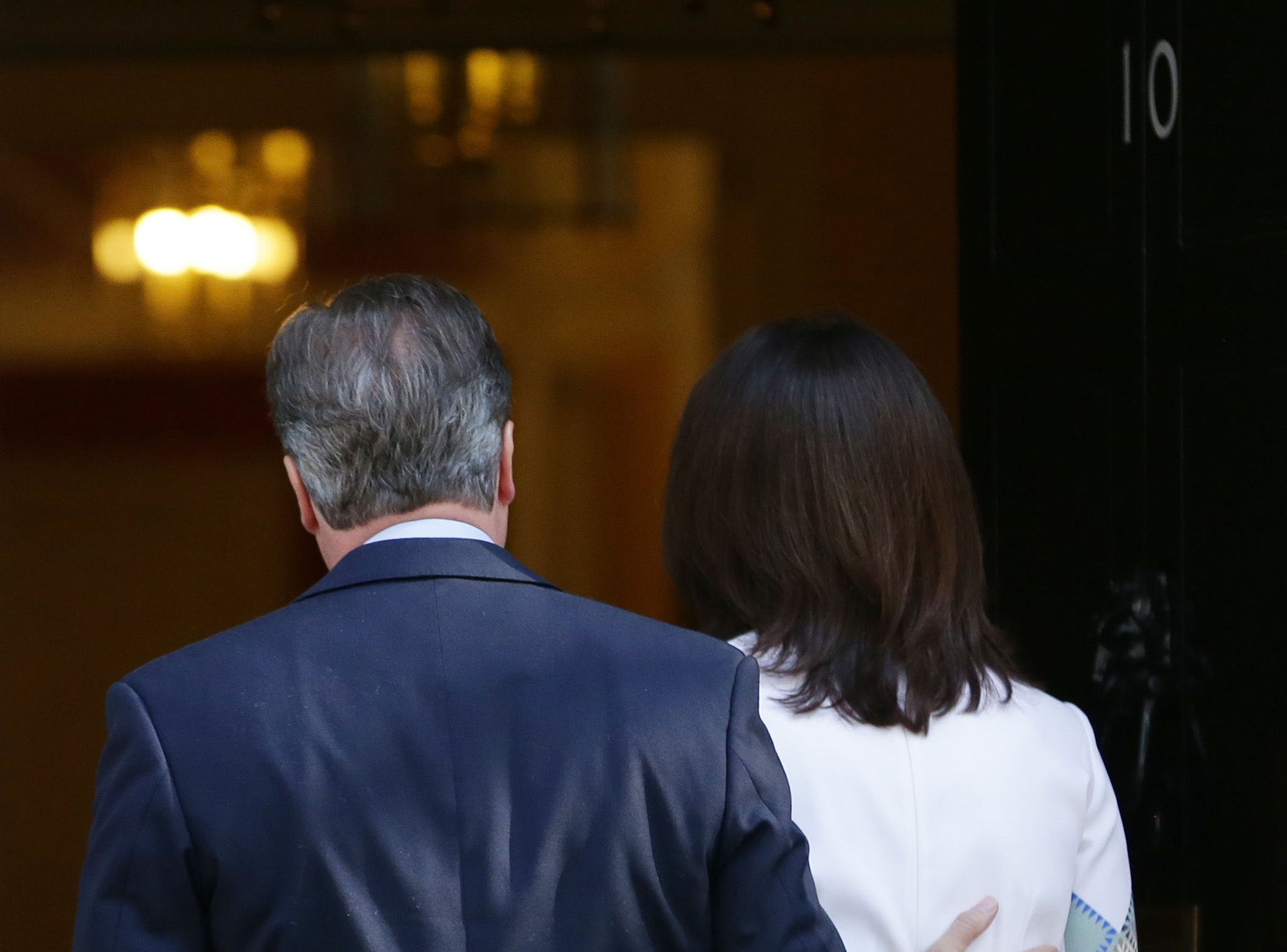 Prime Minister David Cameron walks into 10 Downing Street, London, with wife Samantha after he announced his resignation