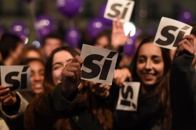 Supporters of left-wing Podemos hold sheets reading 'yes' during a previous general election on 20 December 2015