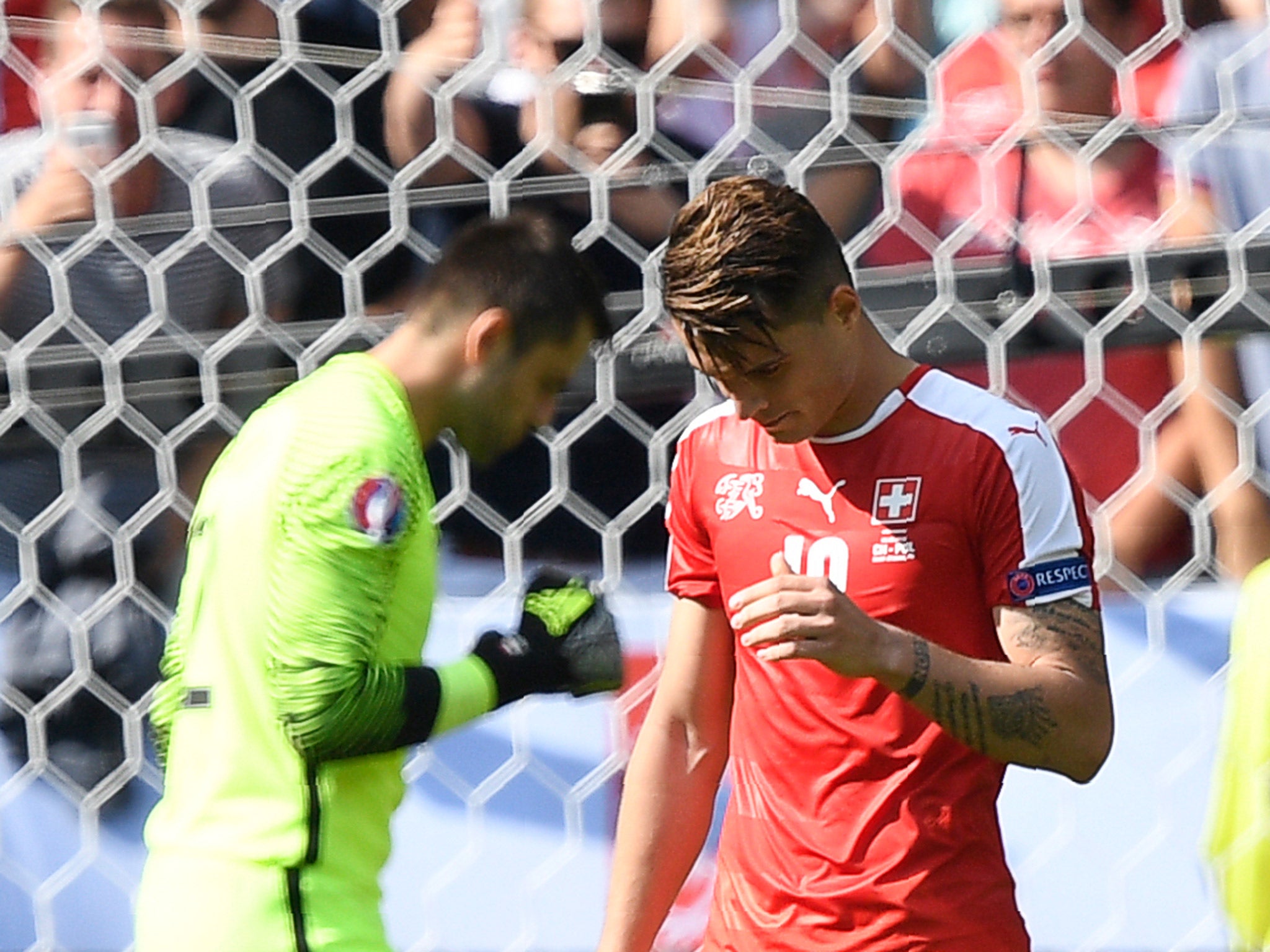 Granit Xhaka reacts after missing his penalty in the shootout defeat by Poland