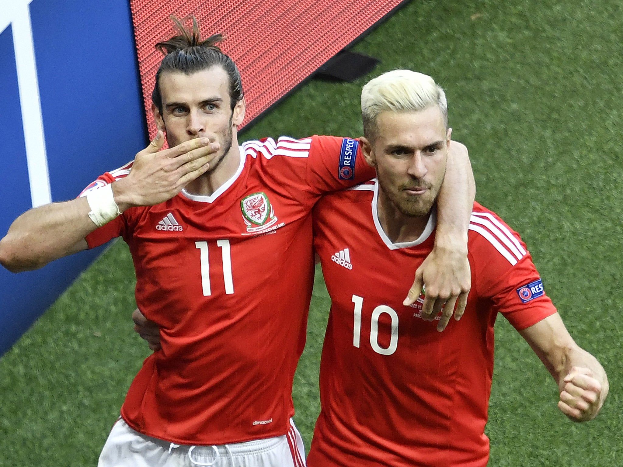 Gareth Bale and Aaron Ramsey celebrate after Gareth McAuley's own goal gives Wales the lead