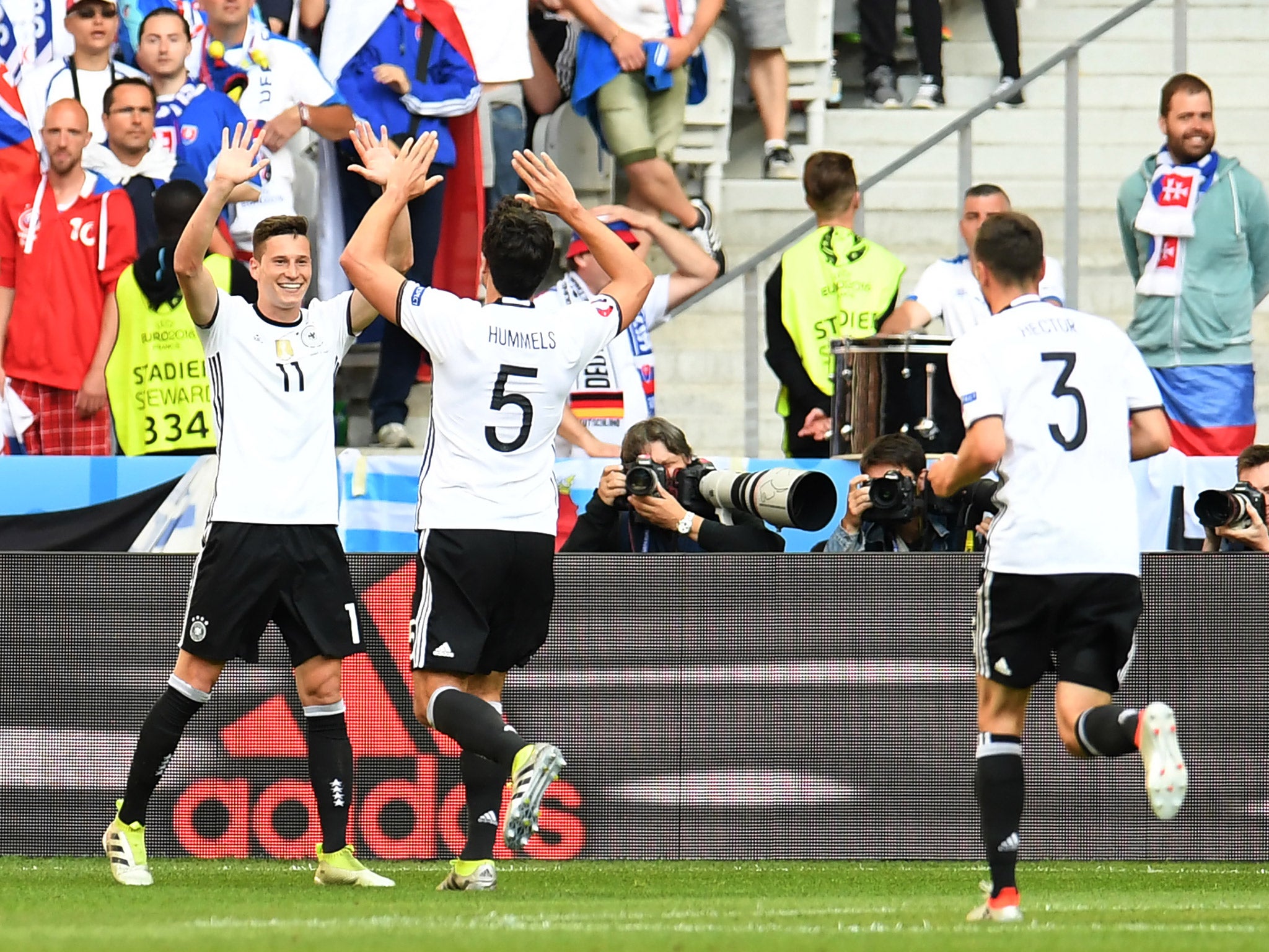 Julian Draxler celebrates with Mats Hummels after scoring for Germany against Slovakia