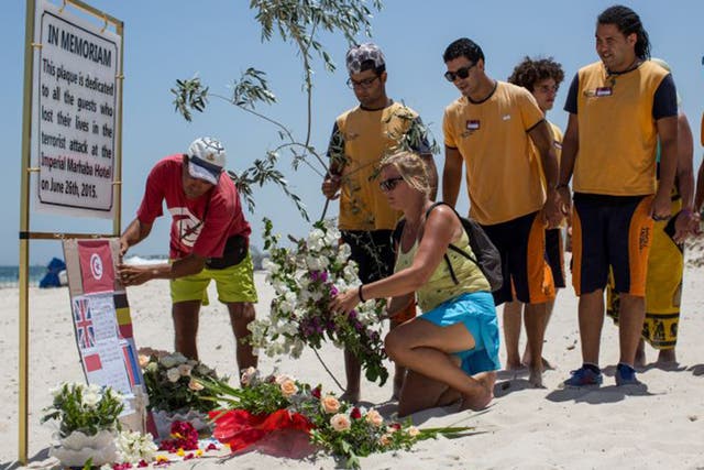 Survivors and family members of victims were joined by hotel staff on the beach in Sousse yesterday