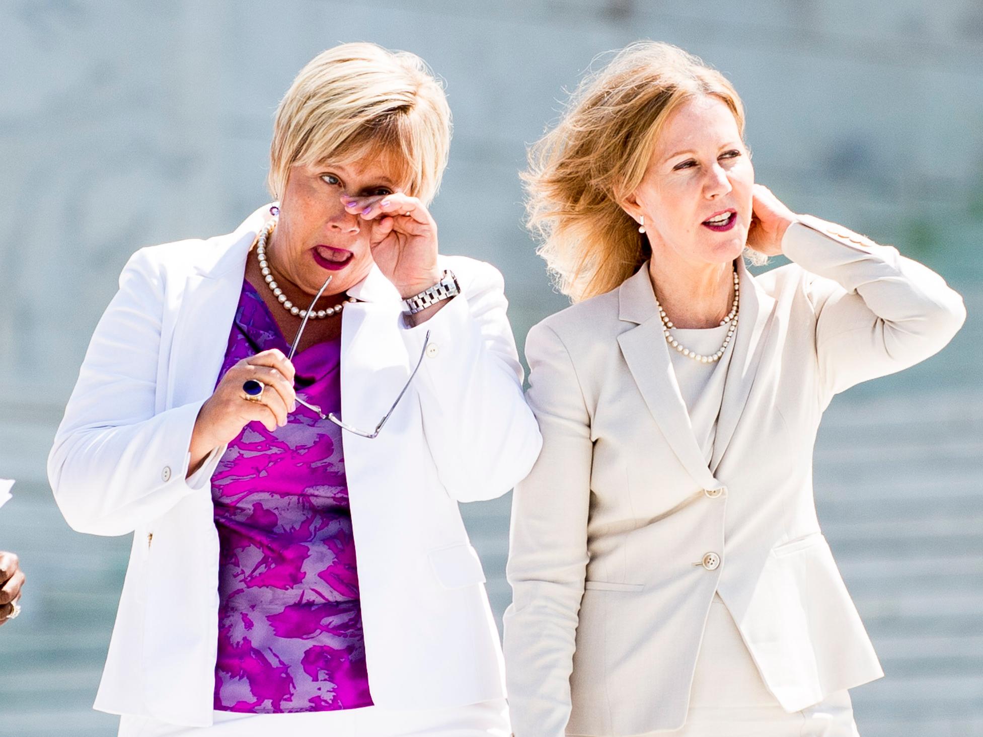 Amy Hagstrom-Miller (left) and Nancy Northrup walk down Supreme Court steps after monumental ruling