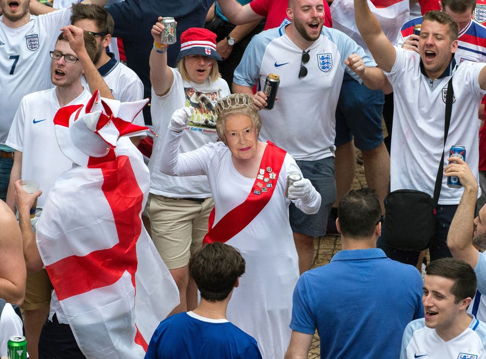 A group of England fans, including one dressed as the Queen, cheer on the national football team at Euro 2016