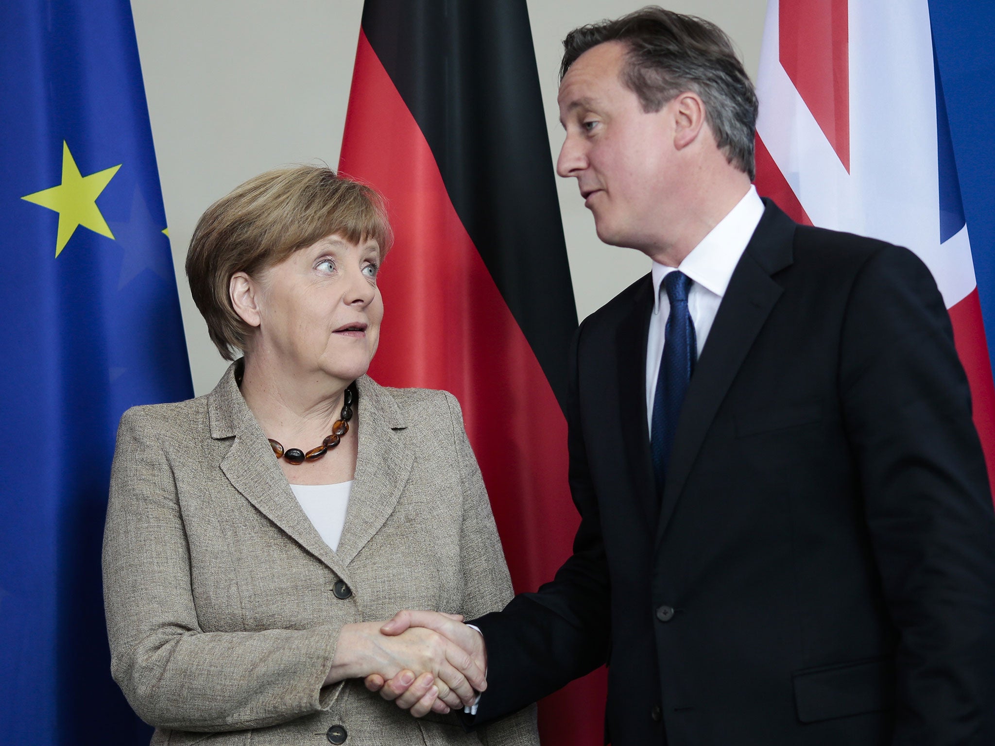 File photo of German Chancellor Angela Merkel, left, and British Prime Minister David Cameron as they shake hands after a news conference following a meeting at the chancellery in Berlin, Germany, May 2015