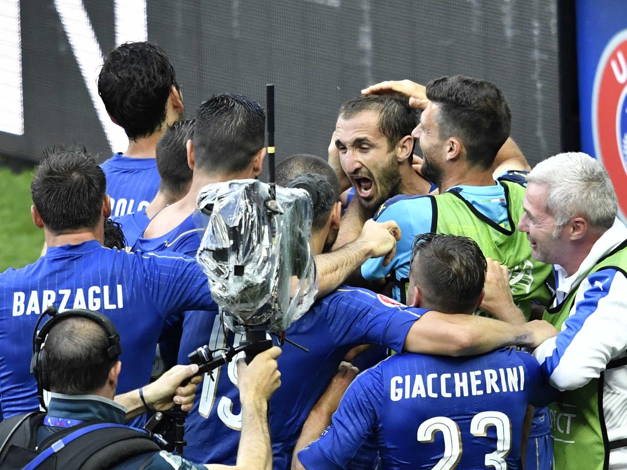 Giorgio Chiellini is congratulated by his team-mates after putting Italy ahead