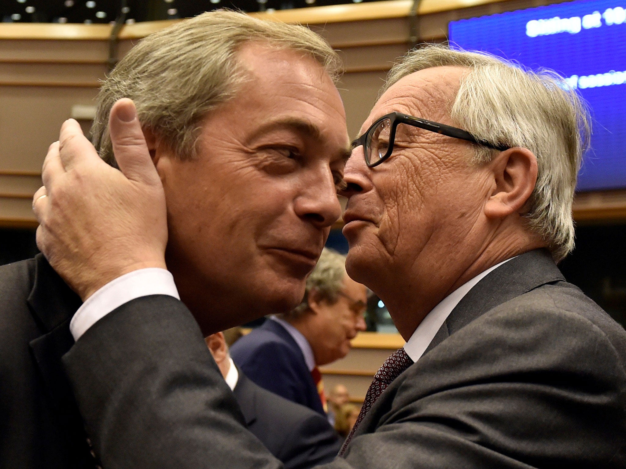 European Commission President Jean-Claude Juncker kisses Nigel Farage prior to a plenary session at the European Parliament on the outcome of the "Brexit" in Brussels, June 28, 2016.