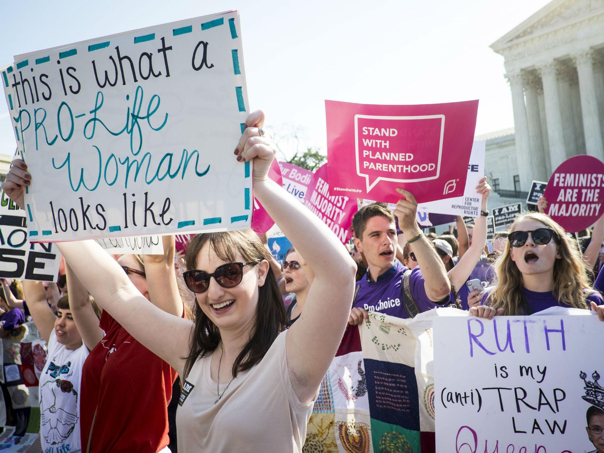 Pro-choice and pro-life activists demonstrate on the steps of the US Supreme Court
