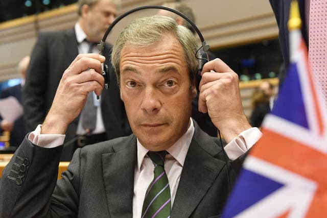 Nigel Farage sits behind a British flag during a special session of European Parliament in Brussels on Tuesday, June 28, 2016