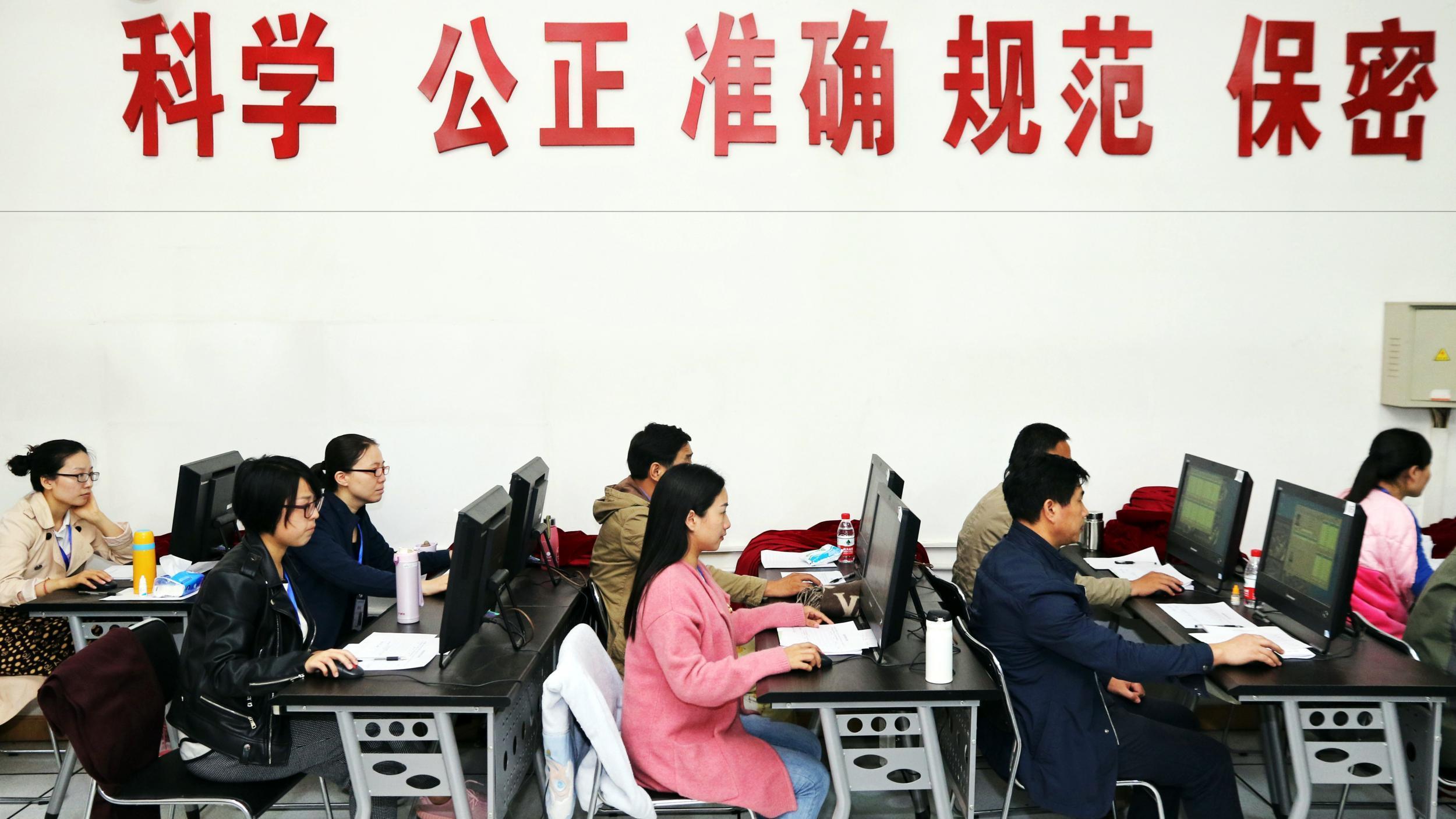 Staff monitor students during a university entrance exam in Zhengzhou in June 2016. Pupils across China sit the annual ‘gaokao’, a national obsession which decides the fates of millions