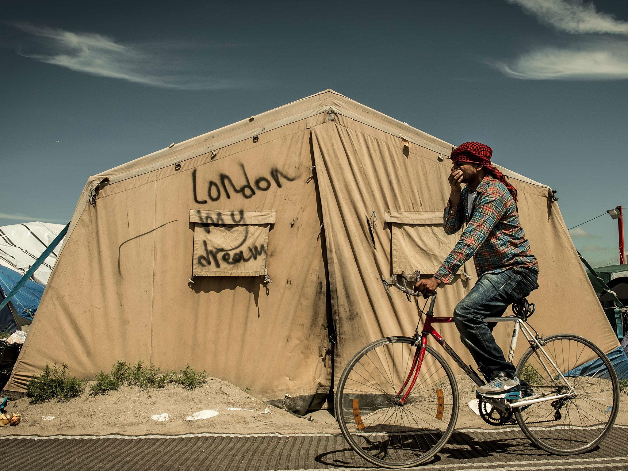 A migrant rides his bicycle inside the "Jungle" camp for migrants and refugees in Calais on June 24, the day after Britain voted to leave the EU. (AFP/Getty Images)