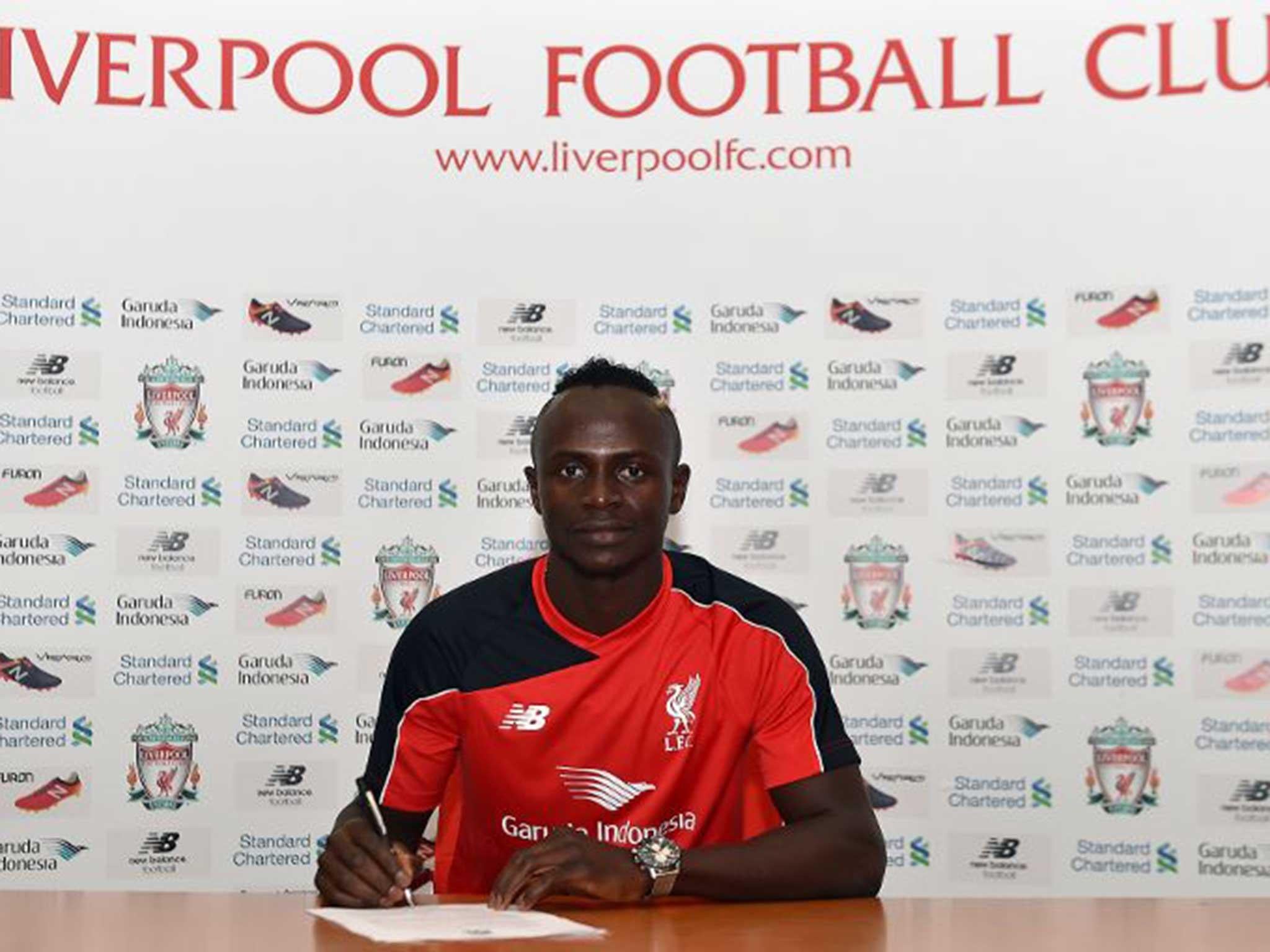 Sadio Mane signs his contract at Liverpool after joining from Southampton