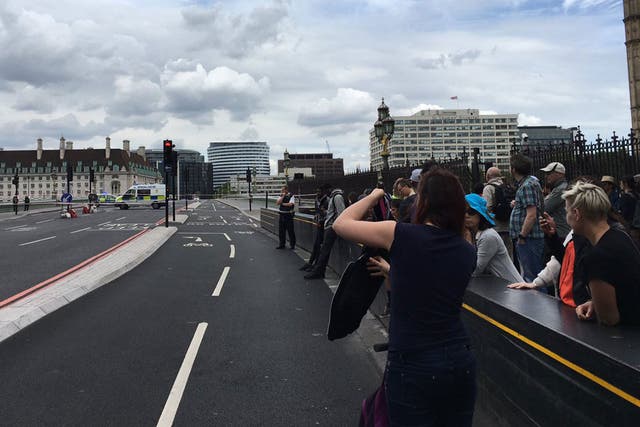 Tourists photographing the police investigation into a suspicious car on Westminster Bridge on 28 June