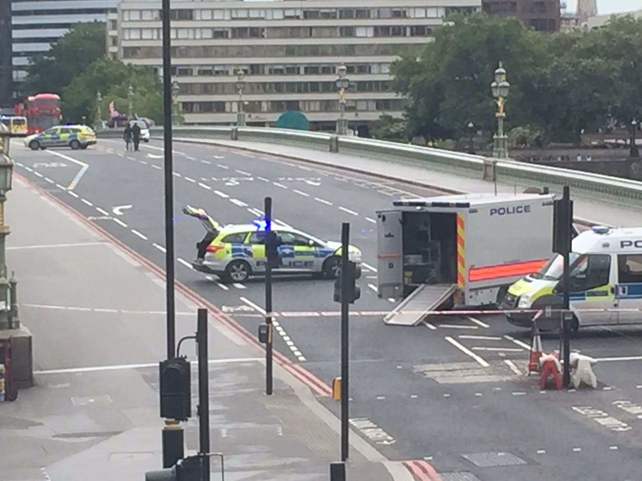 Police escorting the driver back to his car after it sparked a security alert on Westminster Bridge