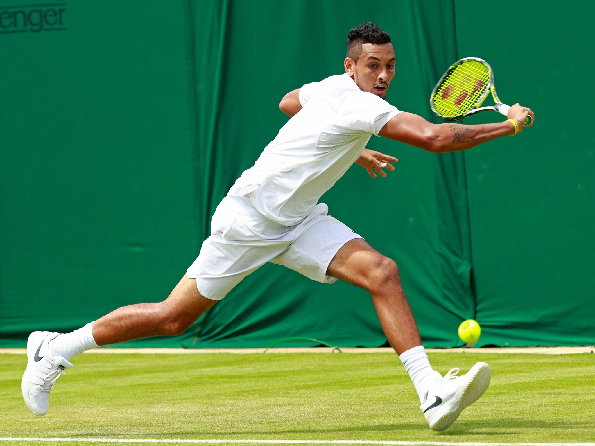 Nick Kyrgios reaches for a backhand during his round-one win