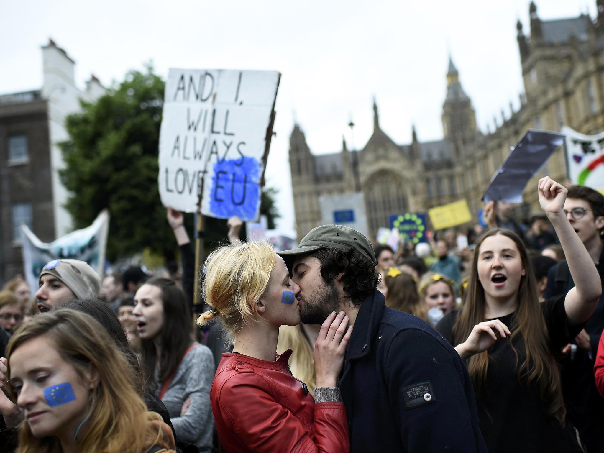 A couple kiss outside the Houses of Parliament during a protest aimed at showing London's solidarity with the European Union following the recent EU referendum