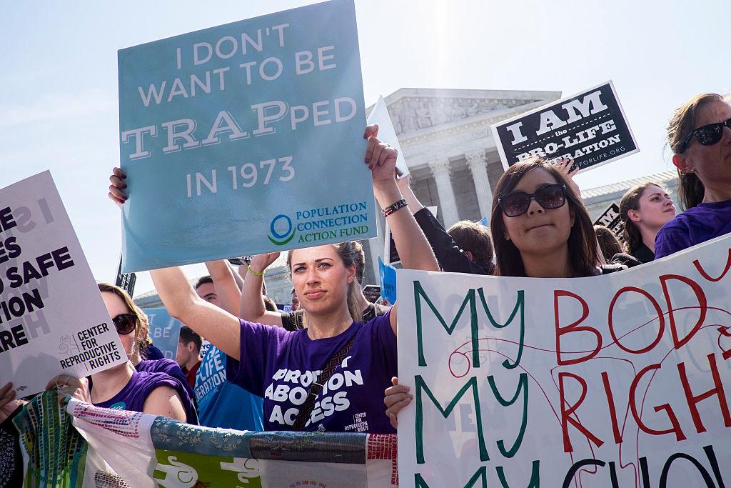 Pro-choice activists outside the US Supreme Court on Monday.