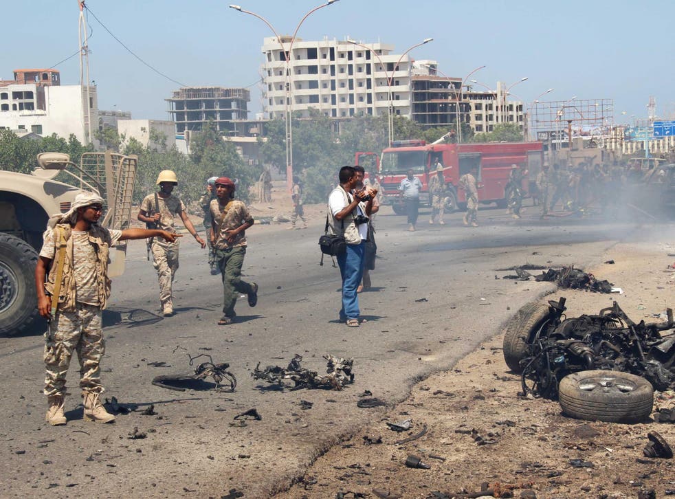 Soldiers gather at the site of a car bomb attack in a central square in the port city of Aden, Yemen, May 1, 2016