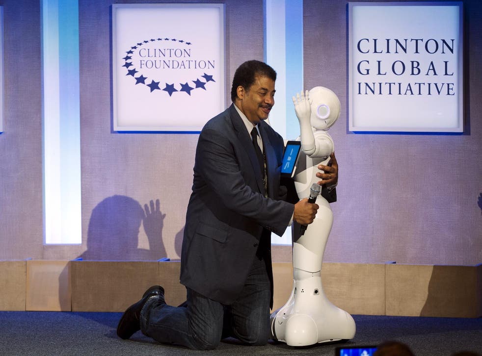 Astrophysicist Neil deGrasse Tyson interacts with Pepper, a social humanoid robot