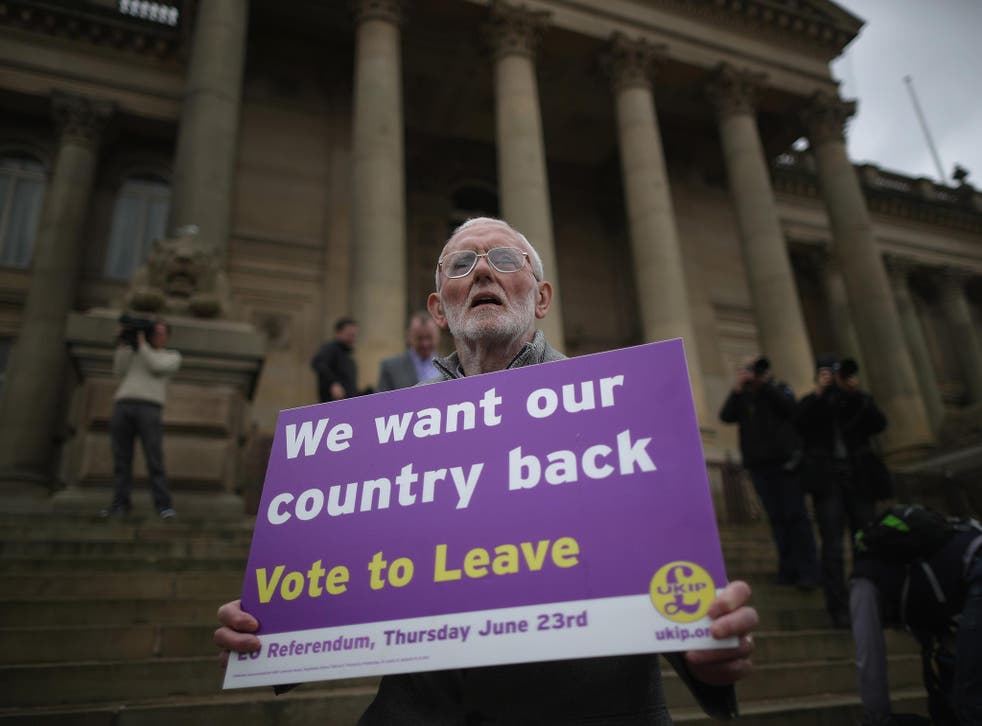 A Vote to Leave campaigner holds a placard in support of leaving the European Union in Bolton, England