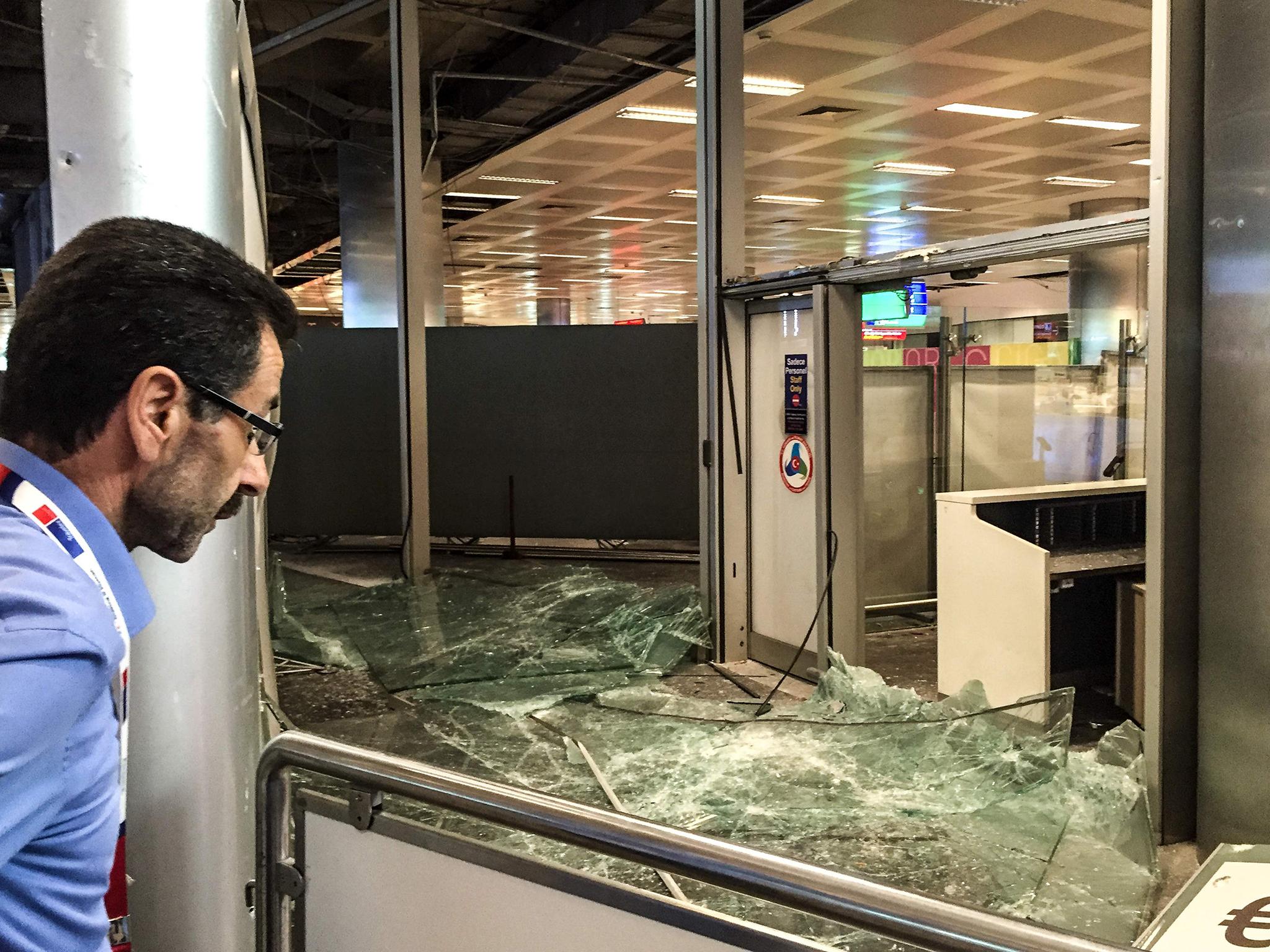 &#13;
A man looks at the damaged explosions site in Ataturk airport's international arrivals terminal &#13;