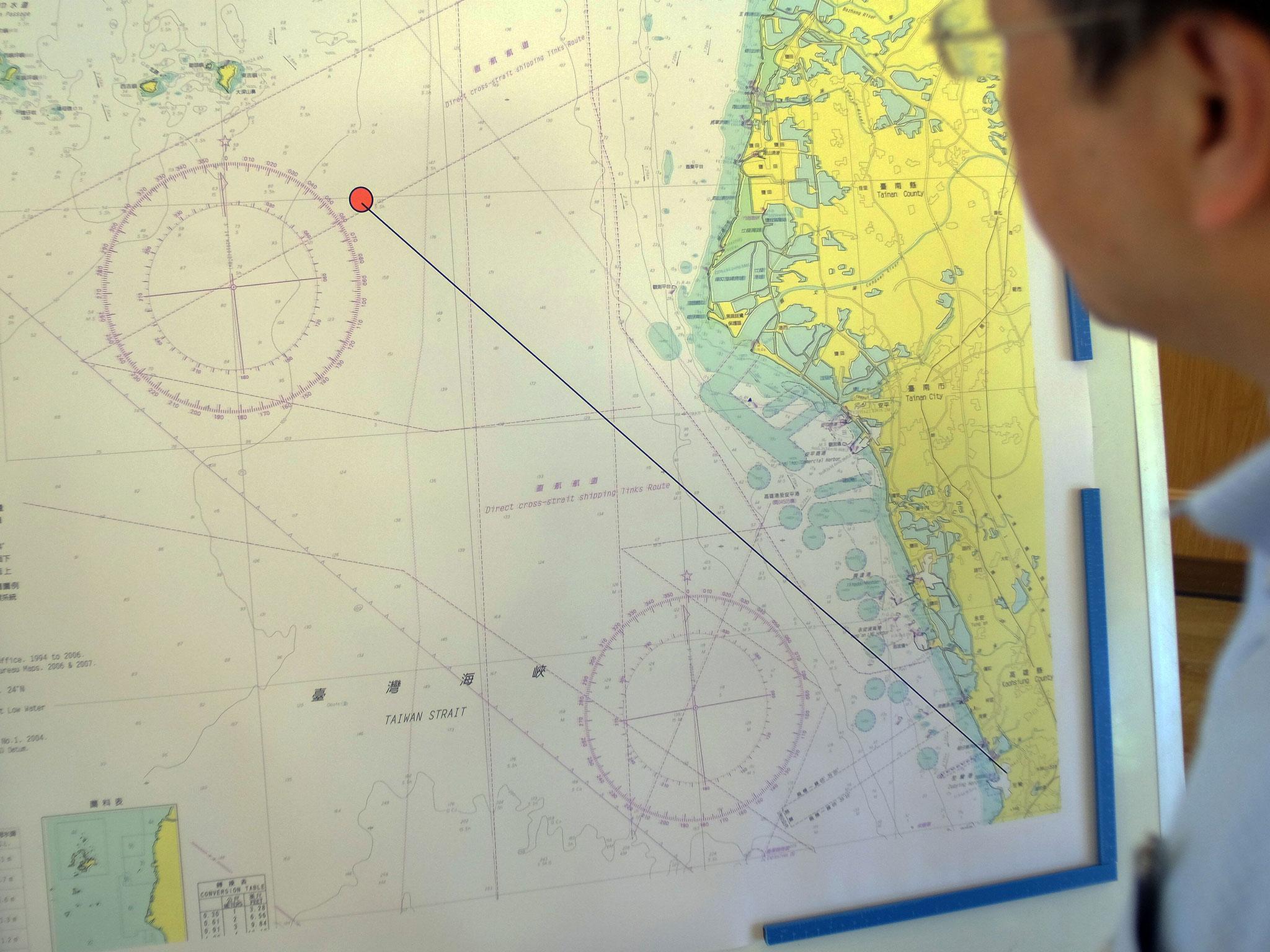 A journalist looks at a map showing the misfired missile route during a press conference in Taipei on 1 July, 2016