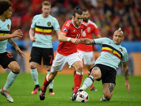 Gareth Bale is tackled by Belgium scorer Ranja Nainggolan in Lille on Friday night (Getty)