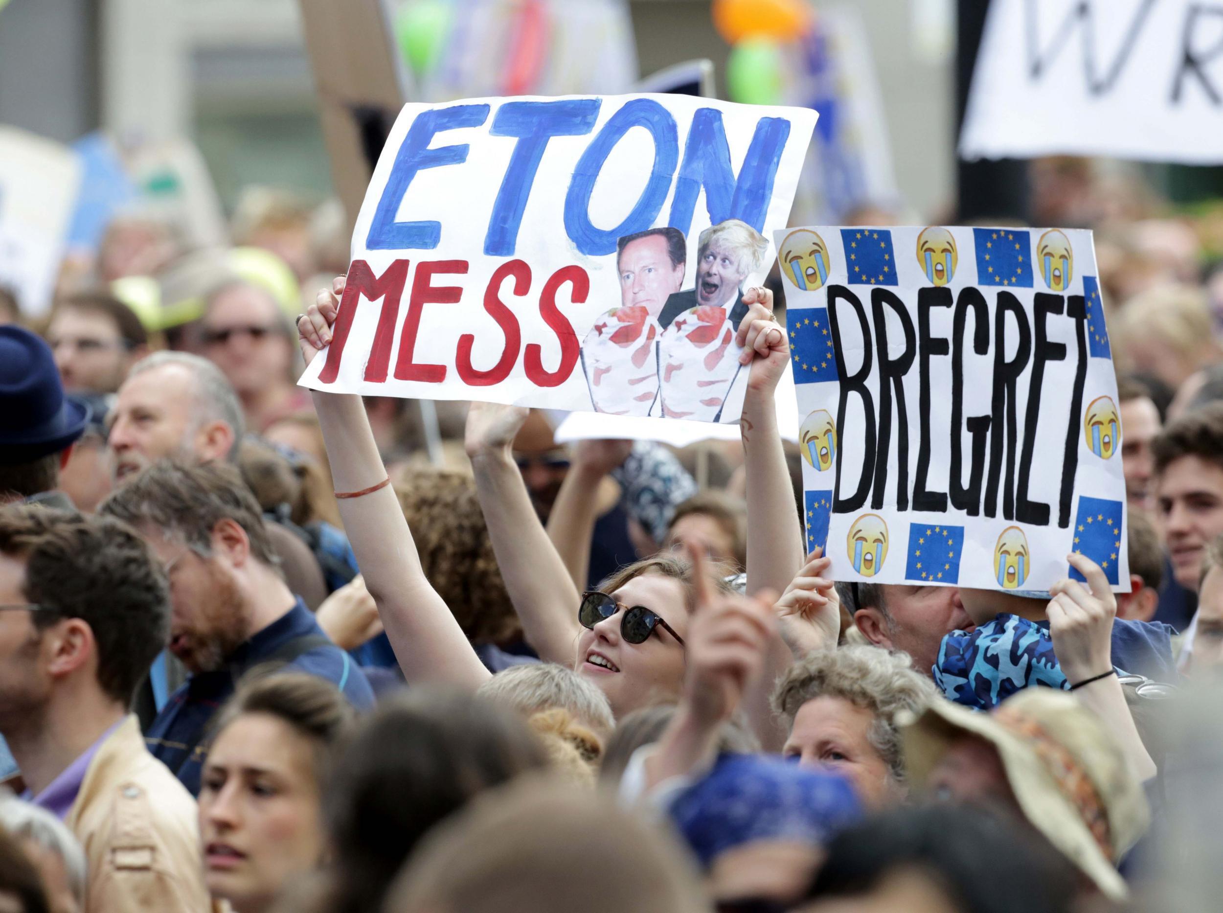 Protesters hold banners calling for EU to remain in the UK