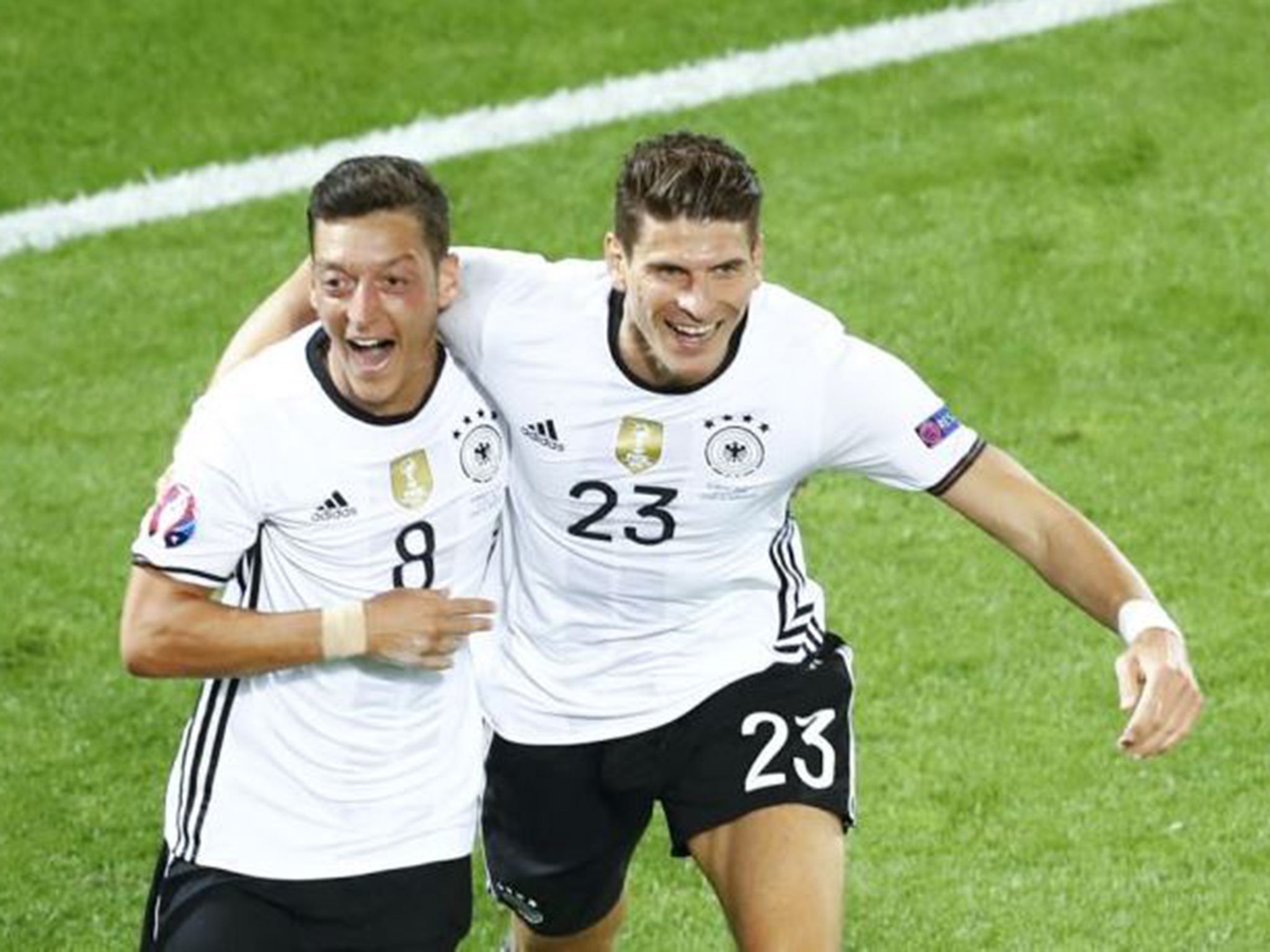 Mesut Ozil is congratulated on his opener by Mario Gomez in Bordeaux