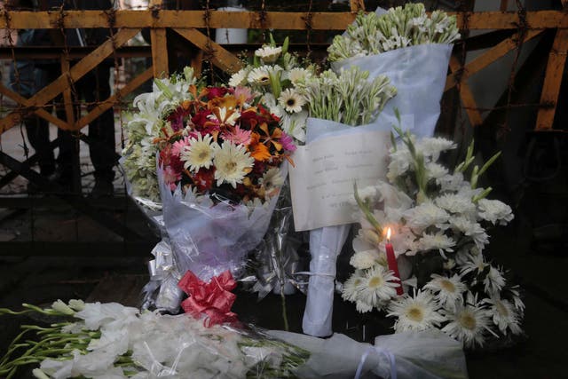 Flowers left at a barricade leading to the Holey Artisan Bakery to pay respects to the hostages who died there