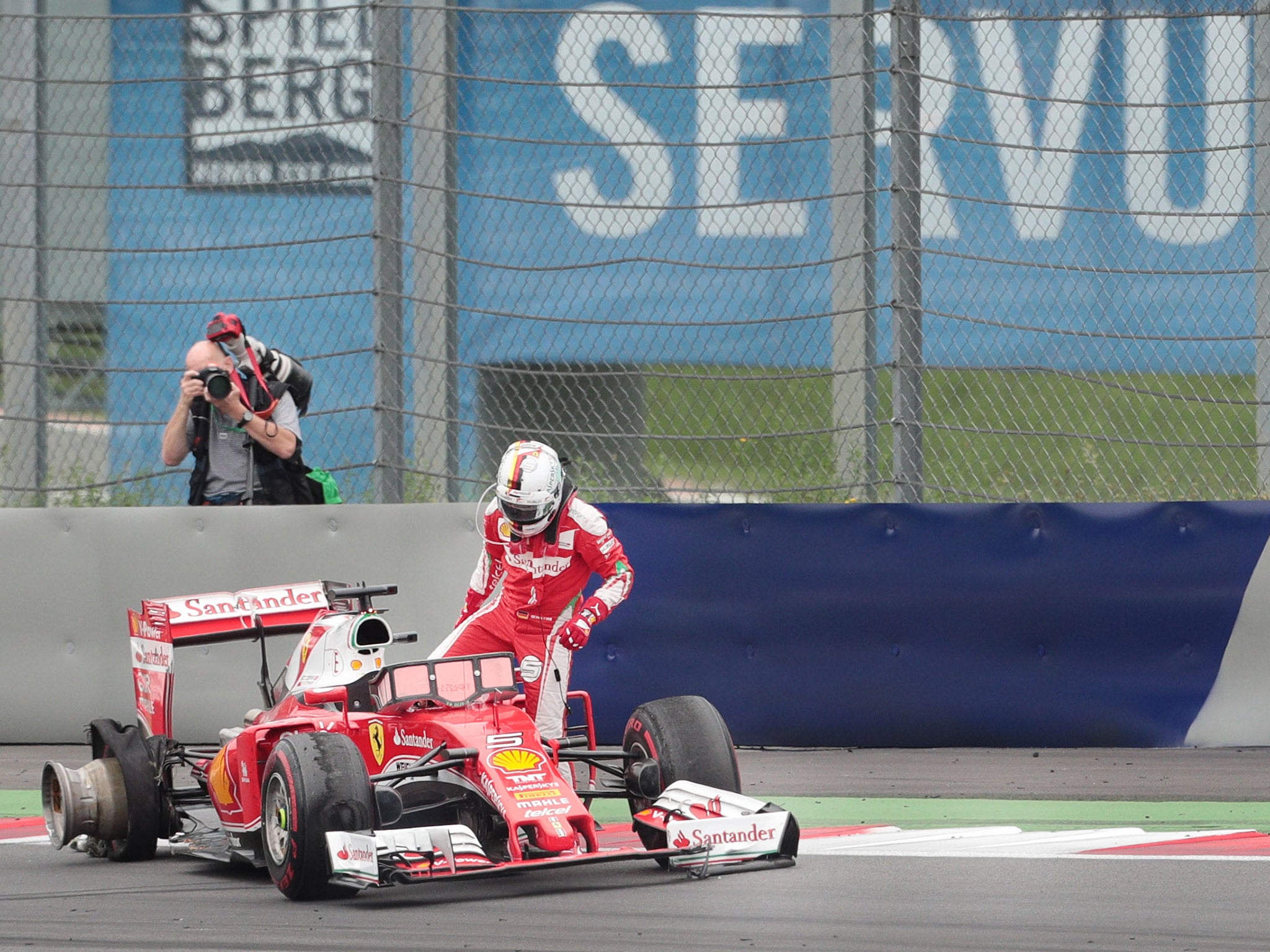 Sebastian Vettel gets out of his stranded Ferrari after crashing out of the Austrian Grand Prix