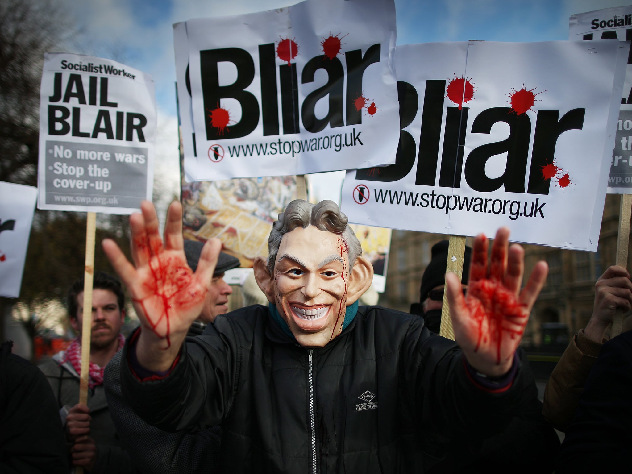 Tony Blair has always denied lying over the Iraq War. Pictured: Stop the War Coalition protester wearing a mask depicting Mr Blair with blood on his hands