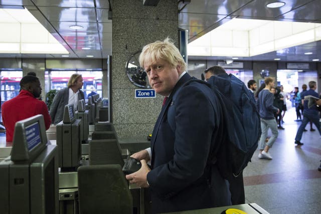 Former London Mayor Boris Johnson enters the London Underground after leaving his Islington home
