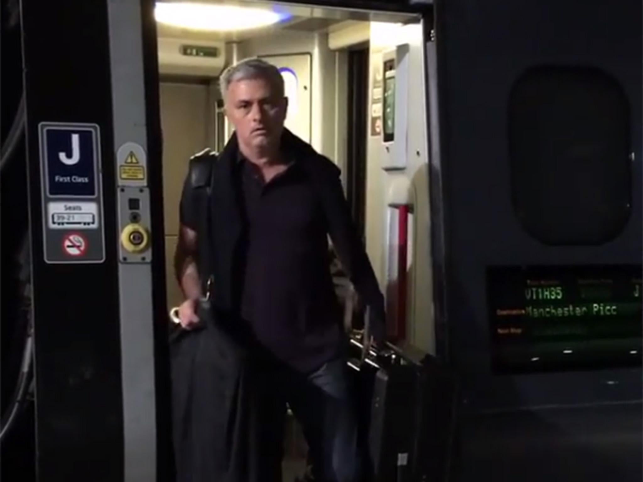 Mourinho disembarks from a train at Manchester Piccadilly station
