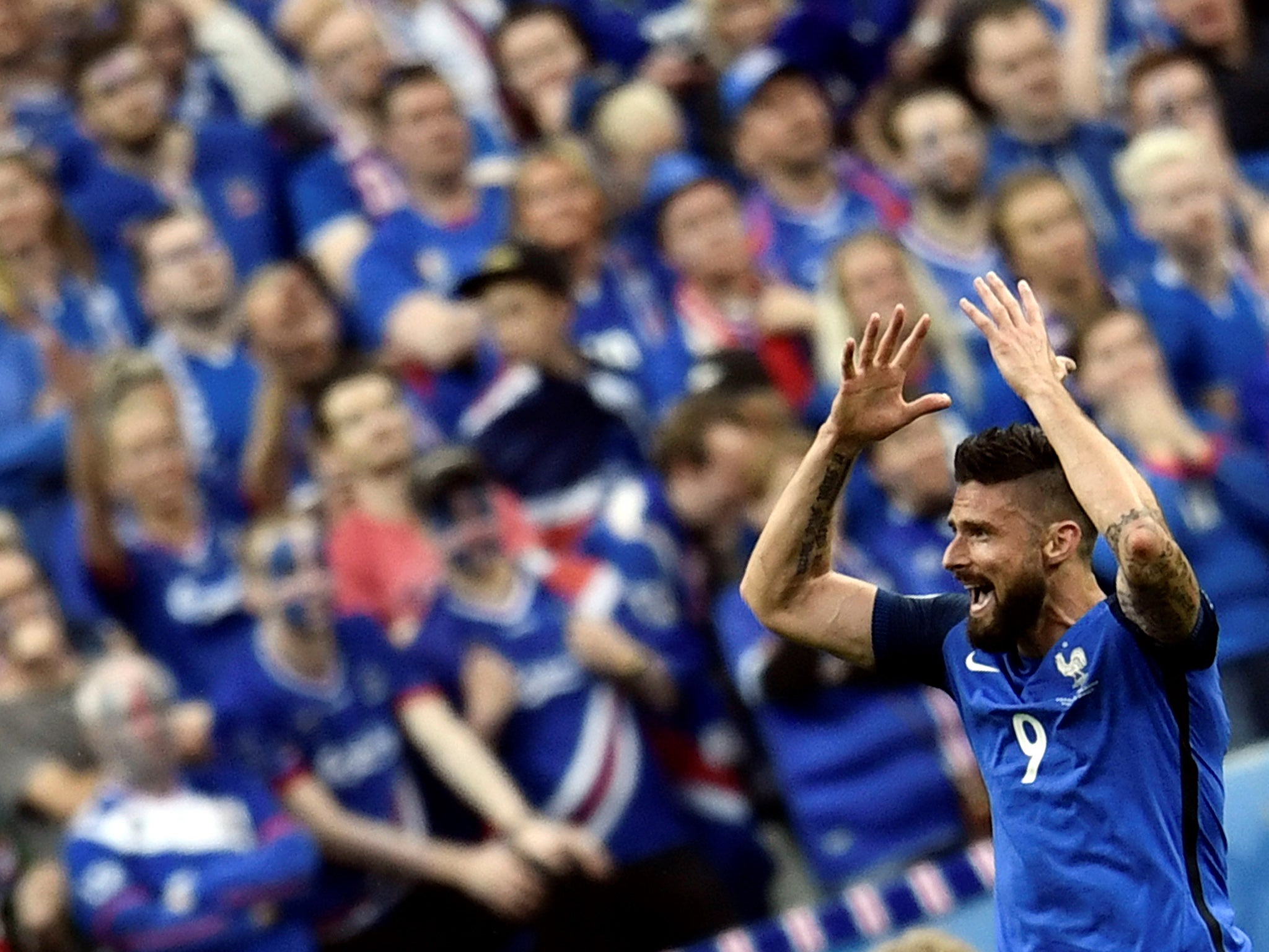 Giroud gestures to the French support during the win over Iceland