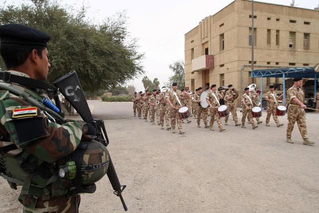A British military band performs in Basra as UK troops hand over control to local forces