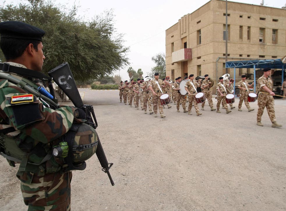 A British military band performs in Basra as UK troops hand over control to local forces