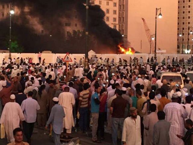 Muslim worshippers gather after a suicide bomber detonated a device near the Prophet's Mosque in Medina